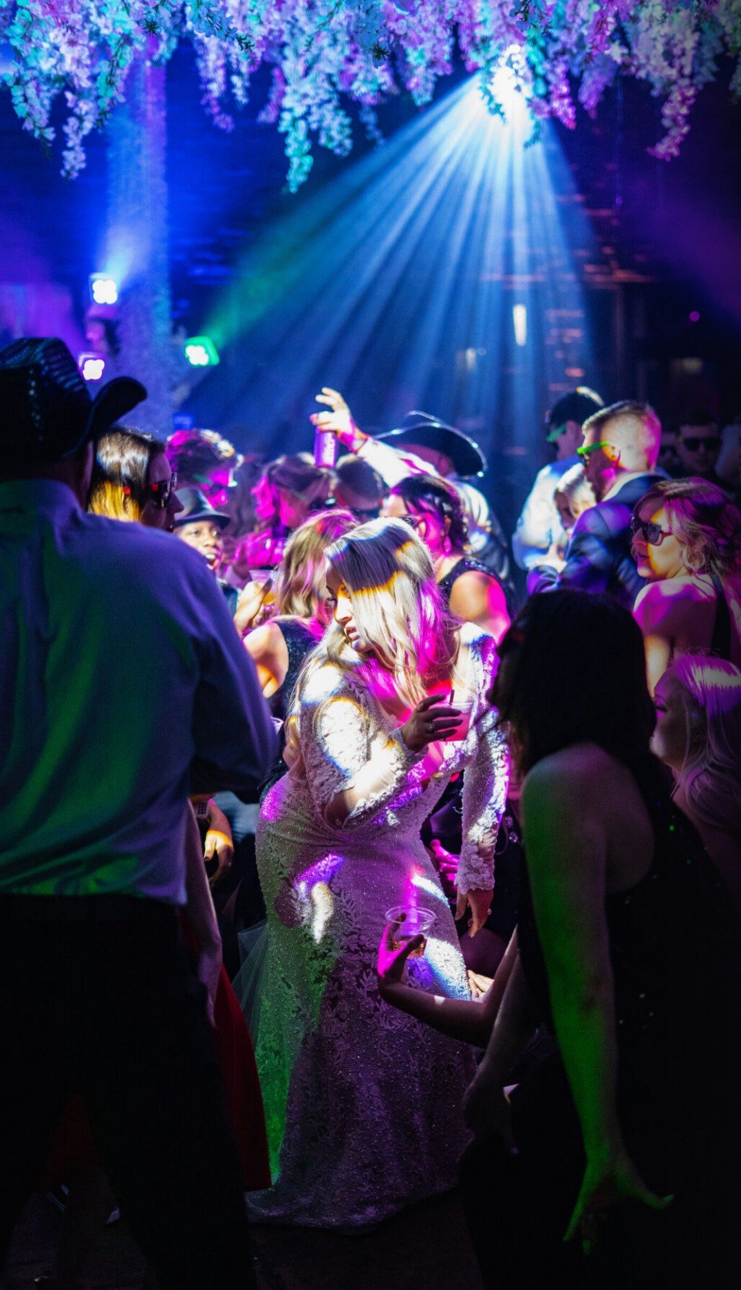 Packed dance floor under blue and pink intelligent lighting