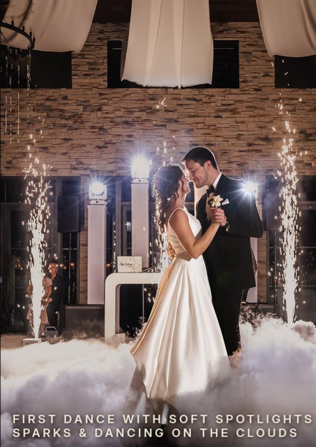 First dance with soft spotlights, sparks and dancing on the clouds