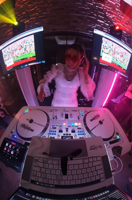 Bride at the DJ booth with headphones