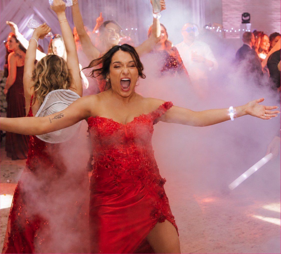 Guest in a red dress dancing through CO2 fog